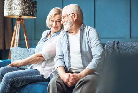 stockphotolovelyseniorcoupledressedcasuallyhavingfunsittingtogetheronthecouchathome1362257870.jpg