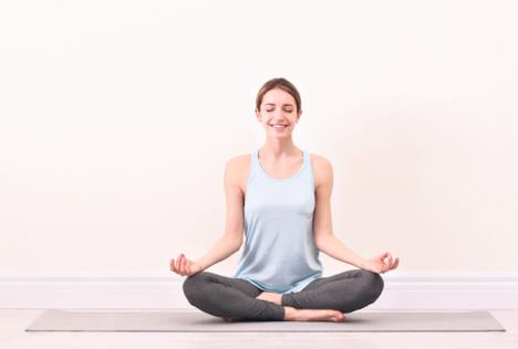 stockphotoyoungwomanmeditatingnearlightwallspacefortextzenconcept1414279769.jpg