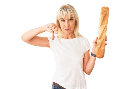 stockphotomiddleagebakerwomanholdingbreadstandingoverisolatedwhitebackgroundwithangryface1500763223.jpg