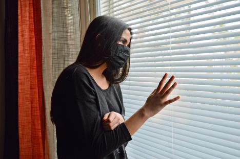 stockphototeenagegirlwithblackfacemaskislookingthroughthewindowwithshadesonshehastostayat1699882627-1203-800.jpg