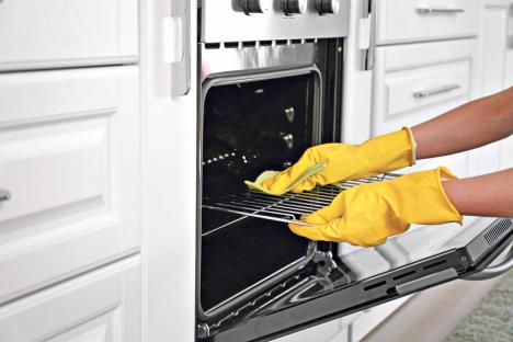 stockphotowomancleaningoveninkitchen1416345794.jpg