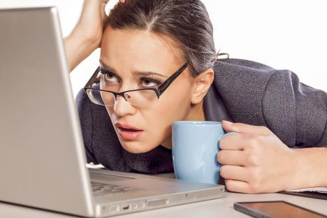 stockphotoverysleepyandtiredbusinesswomanonlaptopholdingacoffeemug229888729.jpg