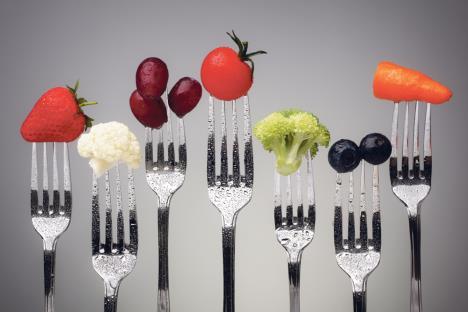 stockphotofruitandvegetableofsilverforksagainstagreybackgroundconceptforhealthyeatingdieting198603971.jpg