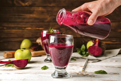 stockphotowomanpouringfreshbeetsmoothieintoglassontable1402195958-1200-800.jpg