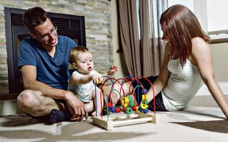 1003-stockphotoaparentsbabysittingonfloorplaywithtoy301504811.jpg