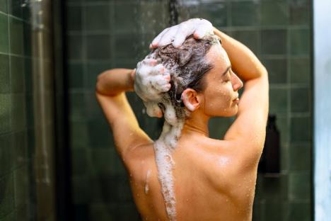 stockphotowomanstayingbackinshowerapplyshampoowithwaterdrippingtakingshowerandrelaxingunder1932221660.jpg