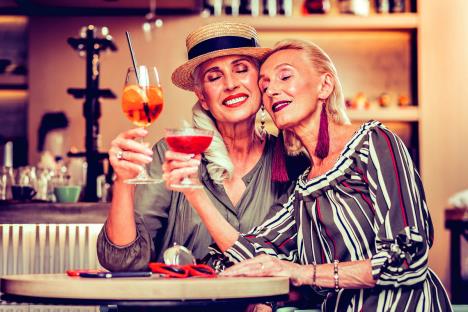 stockphotoholdingcolorfuldrinksattractiveoldladiesmissingeachotherandcelebratingreunionwhile1386330818-sm.jpg