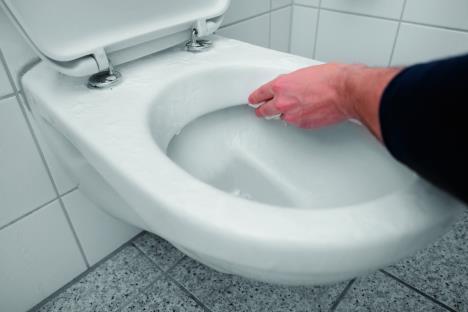 stockphotocleaningthewhitehangingwallmountedtoiletbowlbyhandwithoutgloves1673072860-sm.jpg