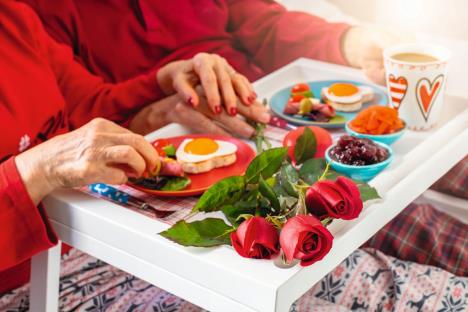 stockphotohandsofanelderlycoupleenjoyingtheirbreakfastatthebedstvalentinesconceptpicture1606302568.jpg