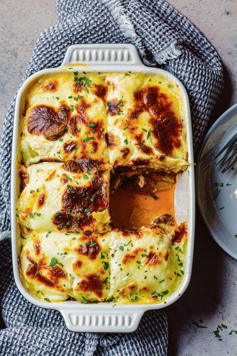 stockphototraditionalgreekpotatoandmeatcasserolewithcheesemoussakadarkbackgroundgreekcuisine1879491037.jpg