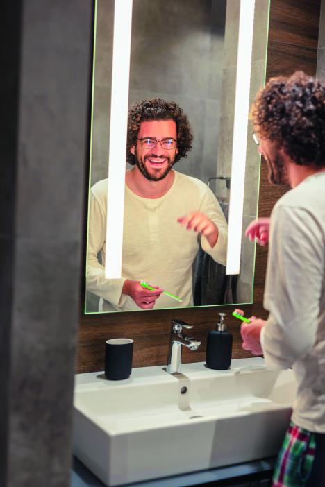 stockphotohandsomeyoungmanwearingpajamasstandinginfrontofmirrorinbathroombrushingteethatnight1791373769-sm.jpg