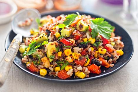 stockphotoblackbeansavocadocorntomatoricequinoasaladwithchillidressing1120448261.jpg