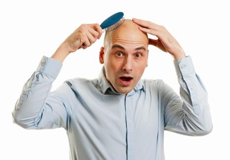 stockphotoshockedbaldmanholdingcomb121024105.jpg