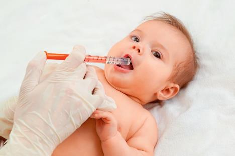 stockphotodoctorgivingremedytobabycutebabygetsmedicinewithasyringeinhismouthbabyhealth1903932568.jpg