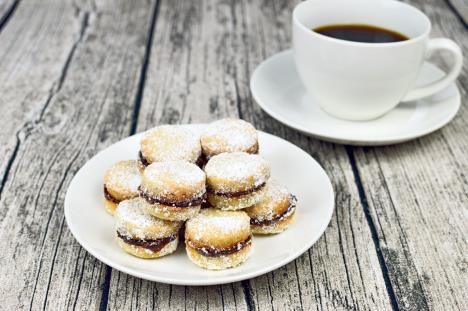 stockphototraditionalserbianhomemadevanillacookieswithjamvanilicepntheplatewithcupofcoffein1676943703.jpg