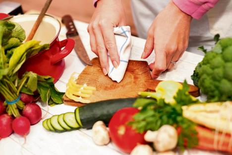 stockphotowomancleaningcuttingboardwithamophygieneinthekitchenconcept635563694.jpg