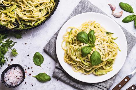 stockphotopastaspaghettiwithzucchinibasilcreamandcheesetopviewongreystonetablevegetarian689300698.jpg