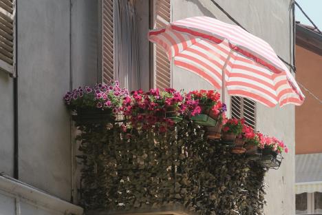 stockphotofloweredbalconywithstripedparasol1129896911.jpg