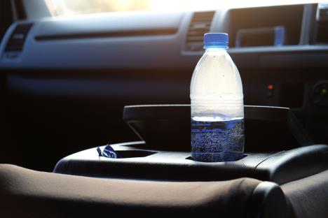 stockphotoadrinkingwaterbottleleftinacarandexposedtosunrise609278408.jpg