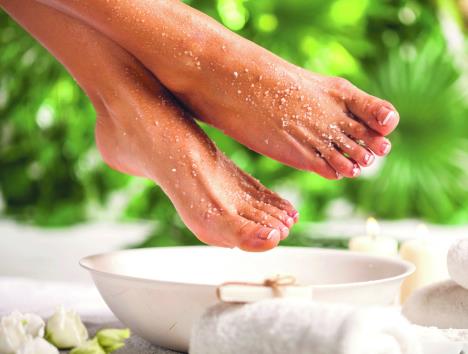 stimulisu-cuvaju-i--greju-stopala-stockphotofemalefeetwithseasaltonwhitefloorandtropicalgreenleavesbackground1275095461.jpg