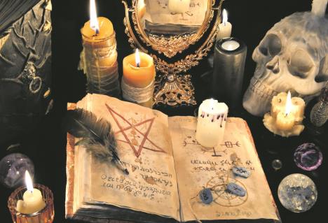 stockphotomysticbackgroundwitholdbookskullcandlesandmirrorhalloweenandoccultconceptblack526881643.jpg