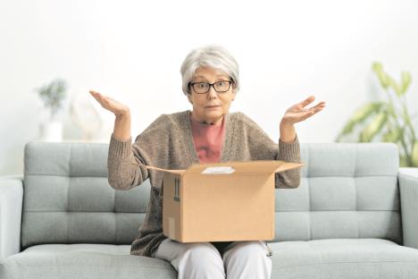 0608-stockphotobeautifulseniorwomanisholdingcardboardboxsittingonsofaathome1906751245.jpg