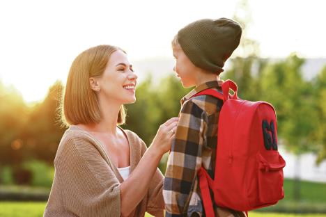 1007-stockphotoyounglovingsmilingmotherleadingsonschoolboywithbackpacktofirstgrademomsittingdown2033072267.jpg