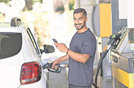 nis-pr-stockphotosmilingmanrefuellinghisluxurycarandmessagingsmartphoneatthegasstationiranianguy2264637195.jpg