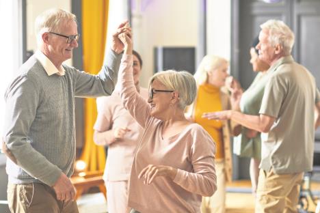 04-stockphotogroupofsmilingseniorpeopledancingwhileenjoyingactivitiesinretirementhomecopyspace2052368663.jpg