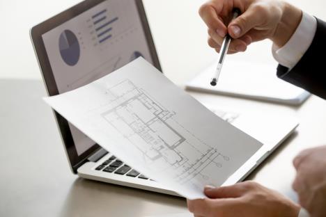 malehandholdingprojectplanstatisticsscreencloseup.jpg