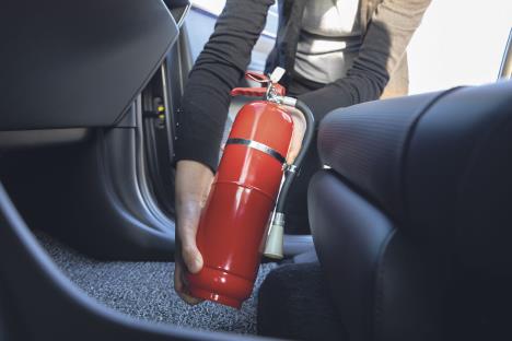 stockphotoinstallingacarfireextinguisherinsideacar2427513223.jpg