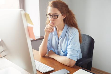 confidentfemalefreelancersittingfrontcomputerwithseriousthoughtfulexpression.jpg