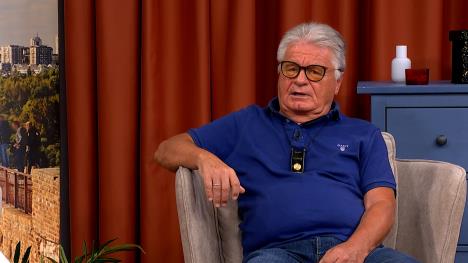 Čovek sa naočarima u fotelji sa plavom majicom