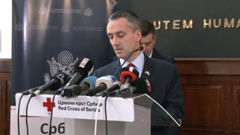 Čovek u odelu sa mikrofonima