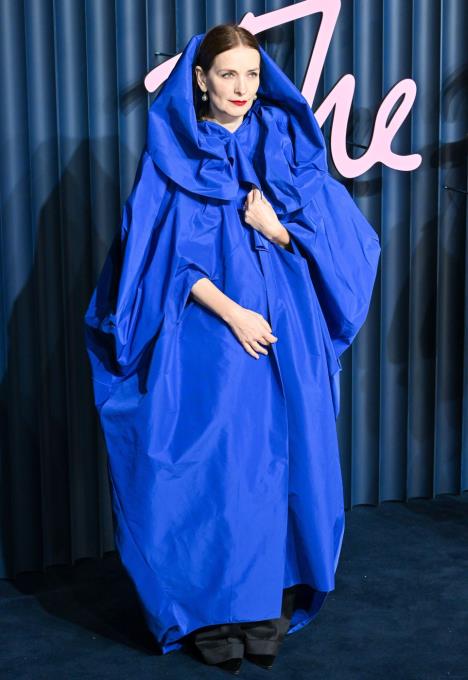 Roksanda Ilinčić u plavoj pelerini sa kapuljačom na crvenom tepihu British Fashion Awards u Londonu.