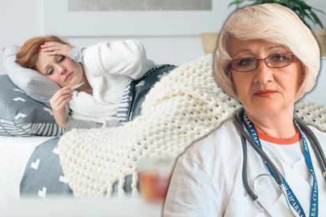 dr Biserka Obradović/žena s gripom leži u krevetu, drži se za glavu i gleda u toplomer