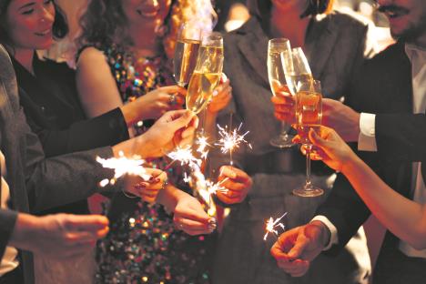 0605stock-photo-sparkling-sparklers-in-the-hands-of-young-friends-people-celebrate-winter-holidays-with-sparkles-2088730000.jpg
