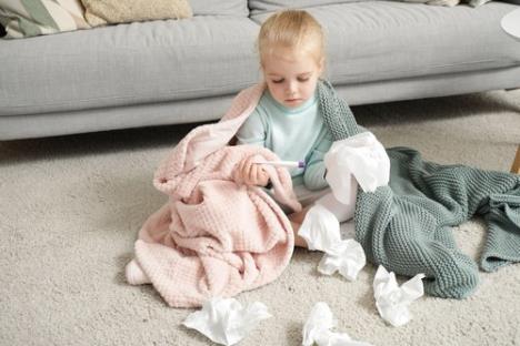 Devojčica se prehladila, na podu se igra sa maramicama i toplomerom