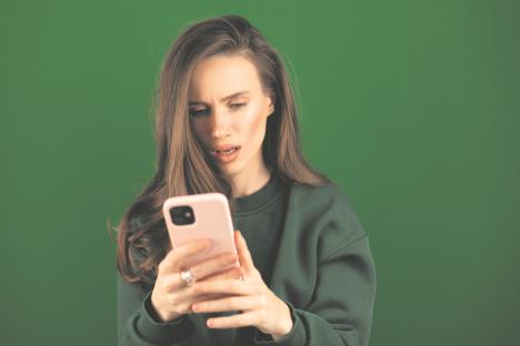 0408 stock-photo-mad-and-shock-young-brunette-beautiful-woman-using-mobile-phone-isolated-on-green-background-2451216281.jpg