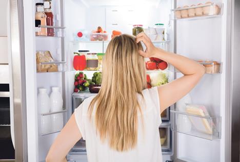 stockphotorearviewofyoungwomanlookinginfridgeatkitchen561872713.jpg