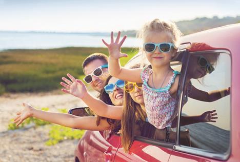 stockphotoportraitofasmilingfamilywithtwochildrenatbeachinthecarholidayandtravelconcept405066019.jpg