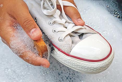 stockphotoshoesorsneakersinawashbasinwithsoapywaterwashingthedirtysneakerscleaningtheshoes599401772.jpg