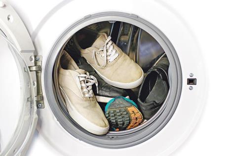 stockphotomanypairsofdirtysneakersinthewashingmachine587486336.jpg