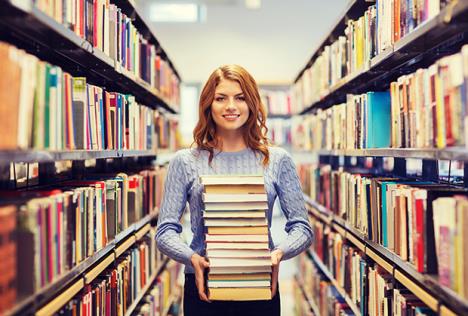 stockphotohappystudentgirlorwomanwithbooksinlibrary371574067.jpg