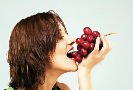 stockphotolovelywomaneatinggrapes98724476.jpg