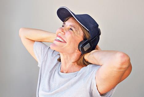 stockphotoportraitofhappyolderwomanwithhatlisteningtomusicwithheadphones586996139.jpg