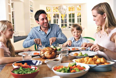 stockphotohappyfamilyhavingroastchickendinnerattable70256782.jpg