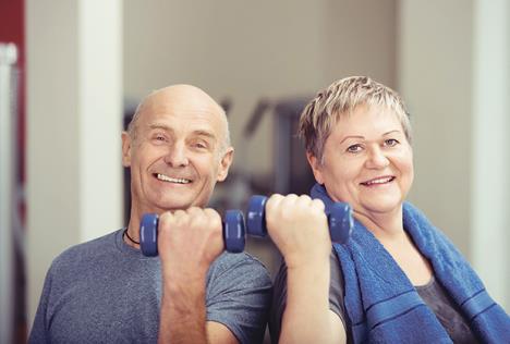 stockphotofitelderlycoupleworkingoutwithweightseachholdingadumbbellinaflexedhandastheytone248868379.jpg