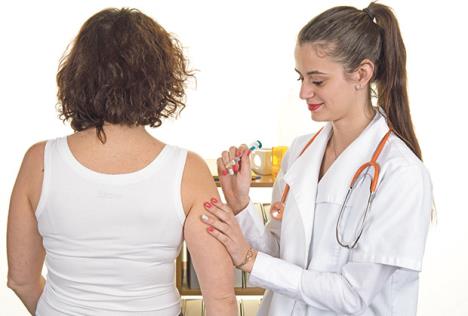 stockphotodoctorfemalegivesanintramuscularinjectioninfemalearm387052972.jpg