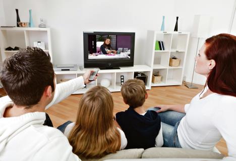 stockphotoyoungfamilywatchingtvtogetherathome129961667.jpg